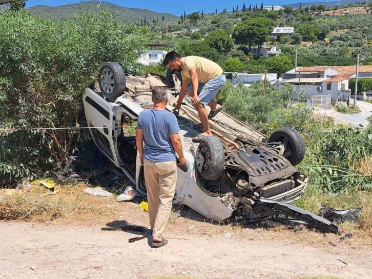 Söke’de virajı alamayan araç takla attı
